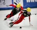 Three skaters in a speed skating race