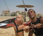 Child doing flying a kite with his father