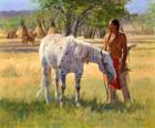 Indian warrior with his horse near the camp