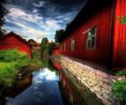 Red houses next to a canal