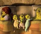 The family of Shrek, Fiona and three young ogres in bed.