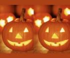 Halloween pumpkins carved with a face and a lit candle inside or Jack O'Lantern