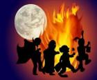 costumed children dancing around the fire