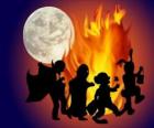 costumed children dancing around the fire
