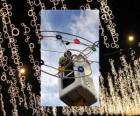operator placing ornamental Christmas lights