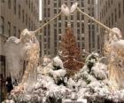 The angels of the Rockefeller Center, covered in snow