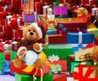 Teddy bear dressed as Santa Claus and with the Christmas gifts