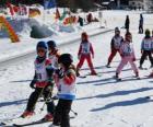 Typical winter scene with children skiing in the mountain