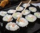 Japanese food with chopsticks, it is known as maki because is sushi rolled with seaweed