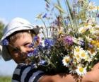 A child with a gift for his mother, a large bouquet of flowers