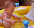 Girl bathing in a small inflatable pool