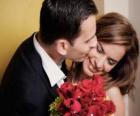 The groom kissing the bride after the wedding