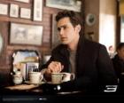 Peter Parker, sitting thoughtfully in a New York cafetria