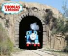 The friendly steam locomotive Thomas coming out of the tunnel