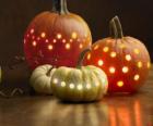 Four Halloween pumpkins with light inside