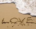 Photo of the word love, LOVE, written on the shore