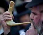 Man playing the shofar. Wind musical instrument typical from Jewish holidays
