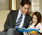 Dad helping reading to his daughter