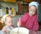 Children preparing a cake as a surprise gift for mom