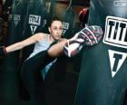 Full contact or kickboxing fighter training hits on the sack