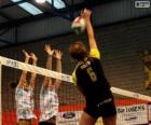 Attack on the network and the defense attempt to block in a volleyball match