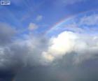 Rainbow between clouds