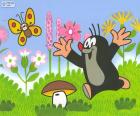 Krtek the Little Mole running down the field, playing with a butterfly