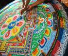 Tibetan priests making the finishing touches to a mandala