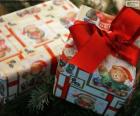 Two Christmas presents, wrapped in a paper with Christmas bears and a red bow