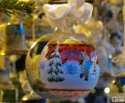 Glass Christmas ball decorated with winter motifs