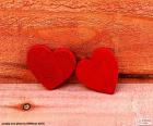 Beautiful composition with two red hearts on a Wood in reddish tones