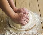Preparing the dough for pizza