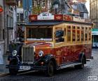 Vintage bus through the streets of the city centre