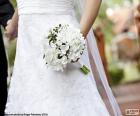 The bride with a beautiful white bouquet in hand