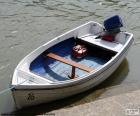 A small white wooden motor boat