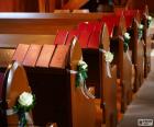 The Church benches adorned with flowers for a wedding