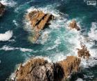 Set of rocks in the sea, the waves break over them