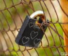 Closed padlock on a metal mesh with five hearts