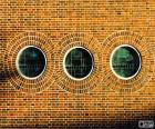 Facade with three round windows forming a drawing