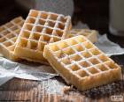 Waffles smothered with sugar icing, is served hot and them can add chocolate, jam, fruits etc...