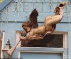 Angel playing a trumpet, hung above the door of a House