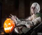 Man disguised in Mummy and a pumpkin with light during the night of Halloween