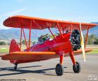 Red biplane aircraft to perform stunts