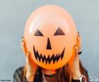 Typical monstrous face of Halloween painted on a balloon