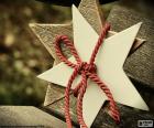 Two wooden stars tied with a red cord