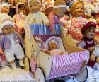 Dolls in a shop, there are large and small, including a stroller for them in wood