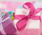 A gift Christmas wrapped with paper and pink ribbon