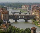 The Ponte Vecchio is a medieval bridge over the Arno River in Florence, Italy