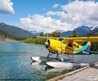 Seaplane biplane yellow on the waters of a Lake