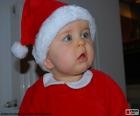 Beautiful blue eyes baby dressed up as Santa Claus